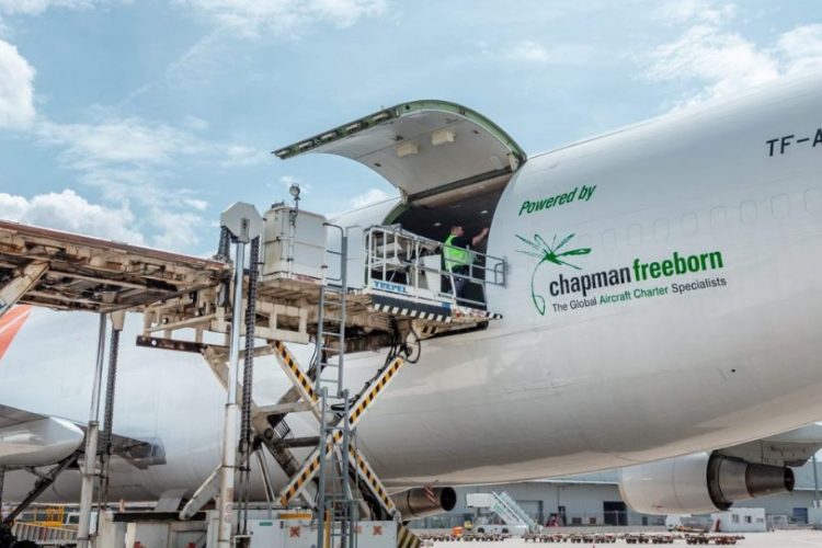 Cargo aircraft being loaded with Chapman Freeborn logo on the side