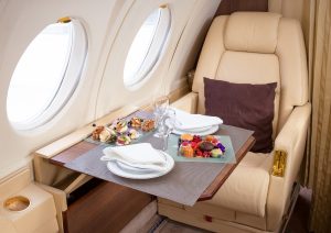Luxurious interior of a private jet airplane with comfortable seating and elegant design.