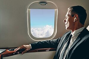 man reading book in a luxurious private jet cabin during empty leg flight