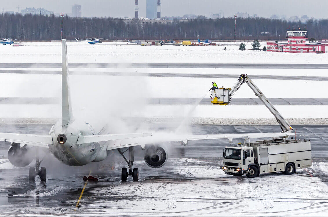 Ground crew provides de icing. They are spraying the aircraft, which prevents the occurrence of frost